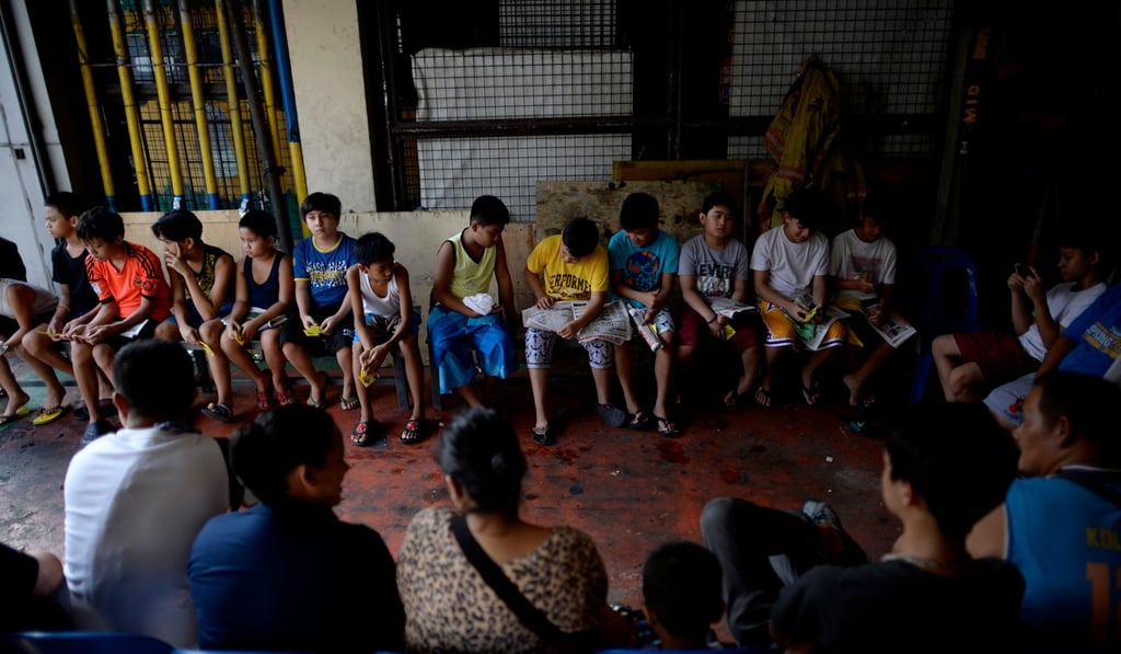 Boys wait in line during a mass circumcision at a village health centre in Manila. Photo: AFP