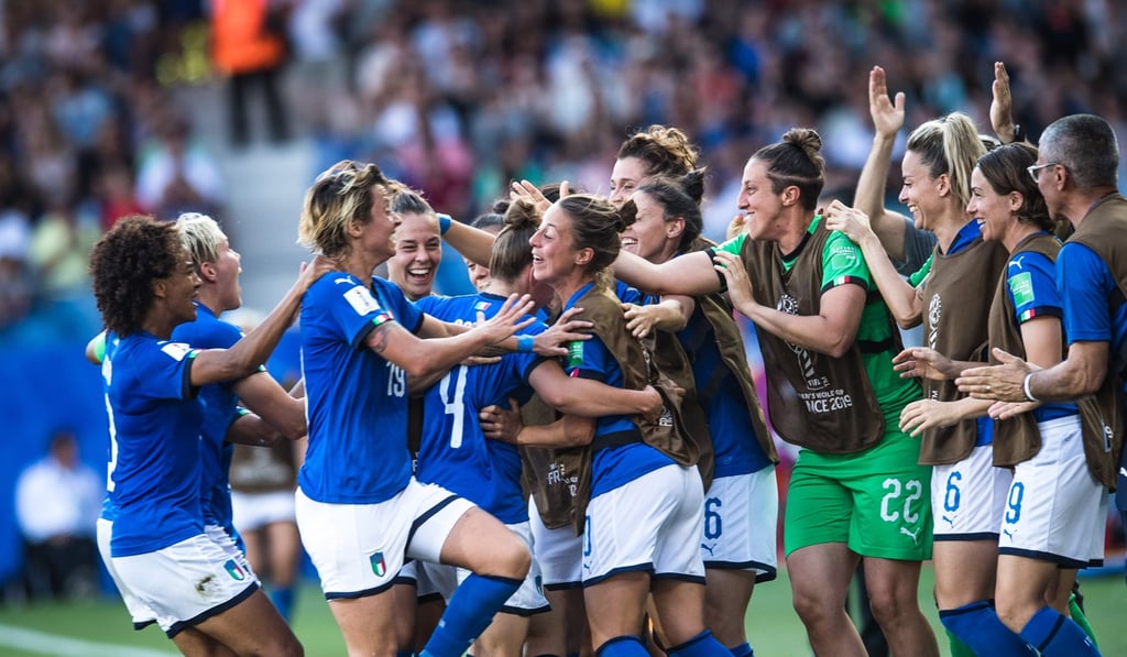Italy’s players and substitutes celebrate opening the scoring. Photo: Xinhua
