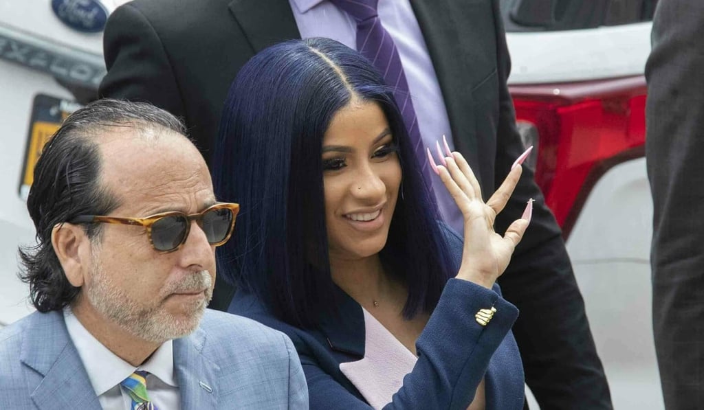 Grammy-winning rapper Cardi B shows off her talon-like hot pink nails as she waves to fans after arriving for Tuesday’s hearing at Queens County Criminal Court. Photo: AP Grammy-winning rapper Cardi B shows off her talon-like hot pink nails as she waves to fans after arriving for Tuesday’s hearing at Queens County Criminal Court. Photo: AP