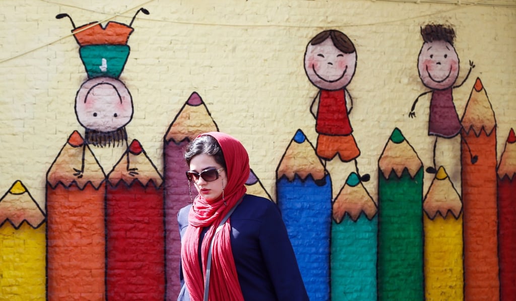 An Iranian woman walk past next to a wall painting in Tehran. Photo: EPA-EFE An Iranian woman walk past next to a wall painting in Tehran. Photo: EPA-EFE