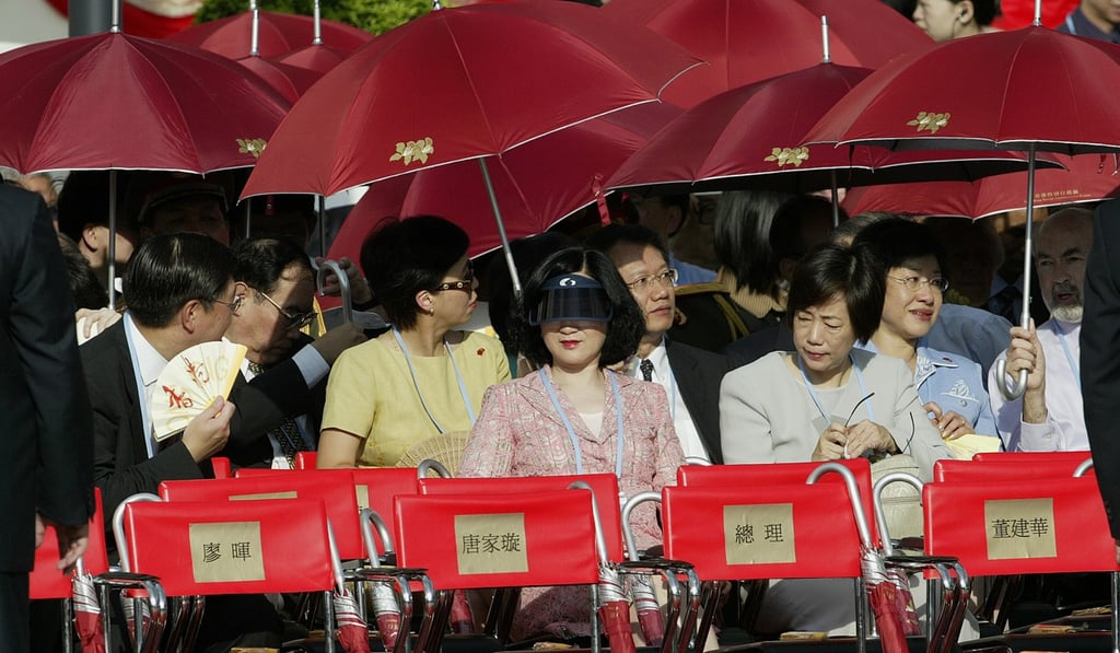 Officials use umbrellas to protect themselves from the sun in the 2003 ceremony, but this year’s July 1 event risks being a washout. Photo: SCMP