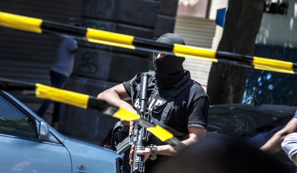 Police take measures at the scene after a suicide bombing targeted a police vehicle in the Tunisian capital in Tunis. Photo: EPA-EFE