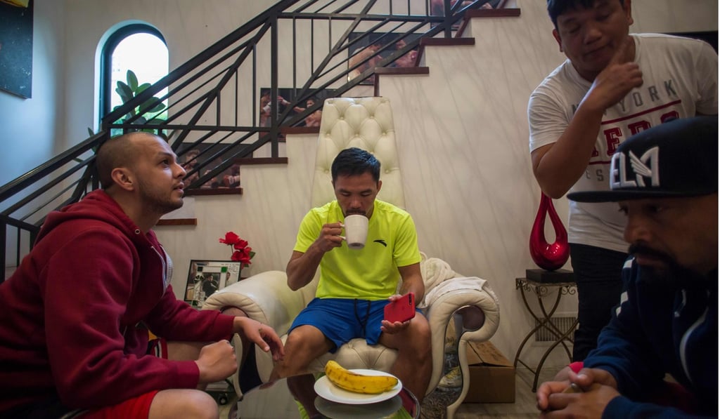 Manny Pacquiao (centre) relaxes in his Los Angeles home after a training session. Photo: AFP