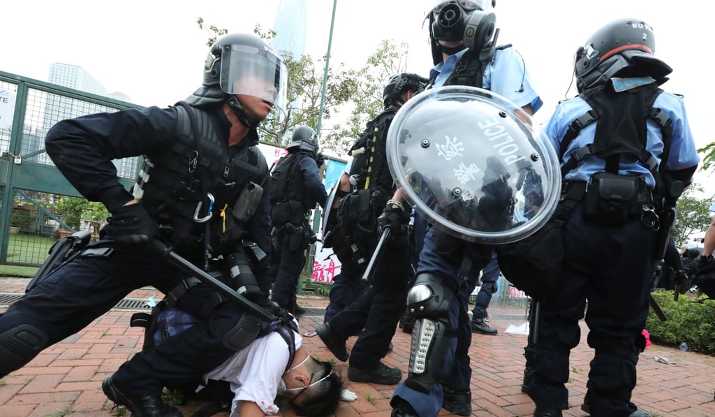 A protester is restrained by police on June 12, in one of several incidents that could be looked at by a full inquiry or police watchdog probe. Photo: Felix Wong