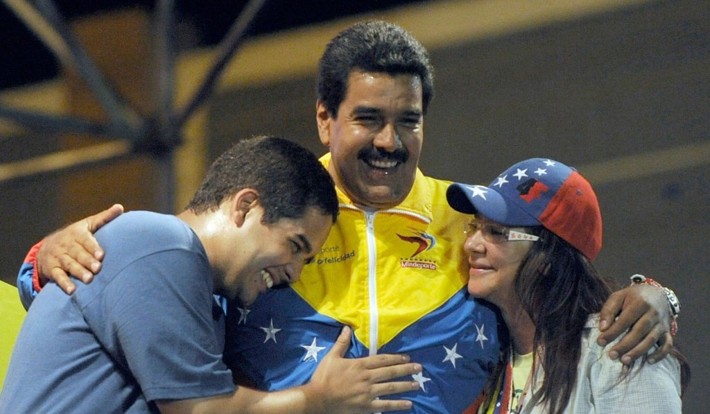 Venezuelan acting President Nicolas Maduro embraces his wife Cilia Flores and son Nicolas Maduro during a campaign rally in 2013. Photo: AFP