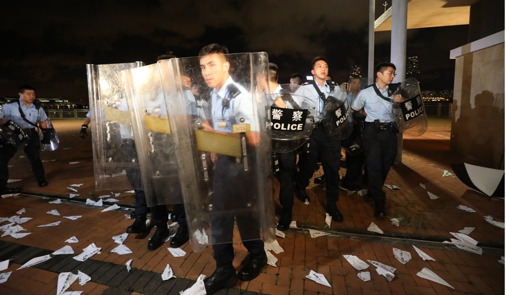 Police officers with riot shields guard the site after clearing the protesters. Photo: Dickson Lee