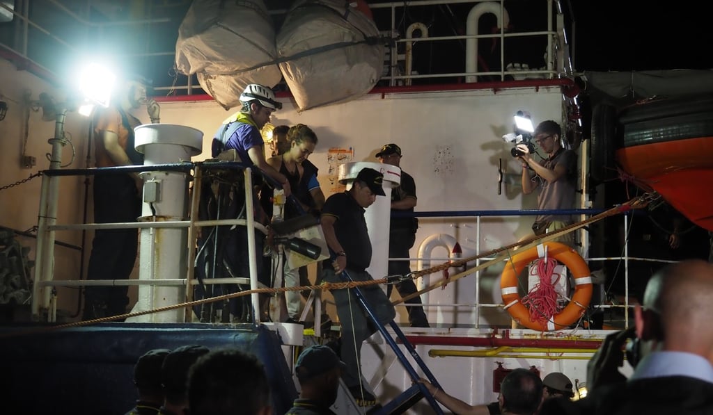 Sea Watch 3 captain Carola Rackete (C) being arrested after entering the port of Lampedusa and ramming a patrol boat, in Lampedusa. Photo: Handout via EPA-EFE Sea Watch 3 captain Carola Rackete (C) being arrested after entering the port of Lampedusa and ramming a patrol boat, in Lampedusa. Photo: Handout via EPA-EFE