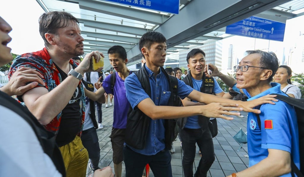 A demonstrator known as Hong Kong Hermit (left) argues with a pro-Beijing protester during a pro-police rally in Tamar on Sunday. Photo: Edmond So