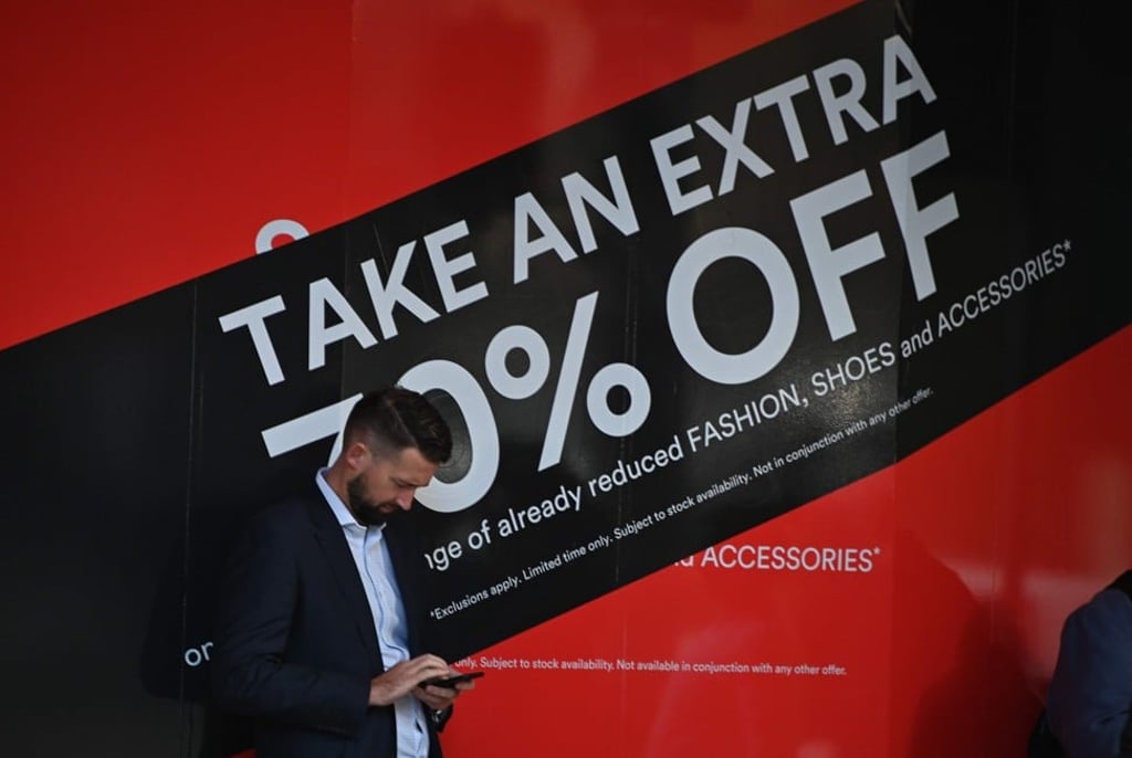 A man walks past a department store in Sydney. Photo: AFP A man walks past a department store in Sydney. Photo: AFP