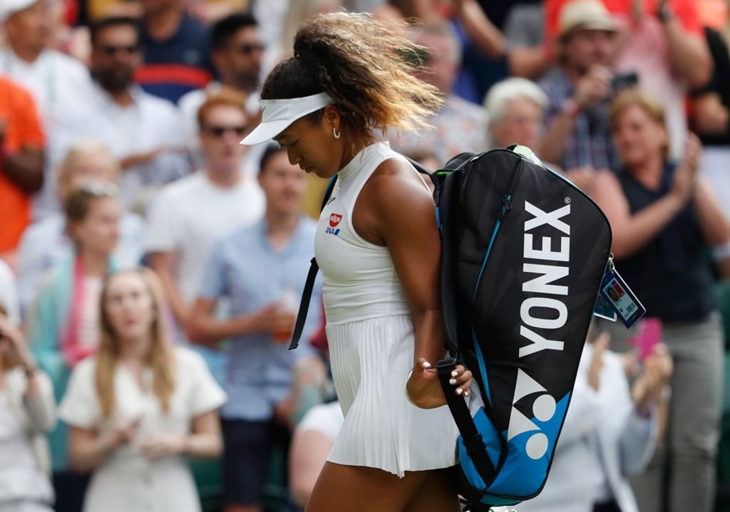 Naomi Osaka trudges off court after being defeated on the first day at Wimbledon. Photo: AFP