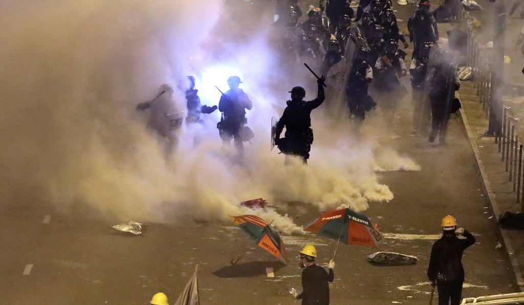 Protesters retreat as riot police clear the area around Admiralty on the 22nd anniversary of Hong Kong's return to Chinese rule. Photo: Sam Tsang