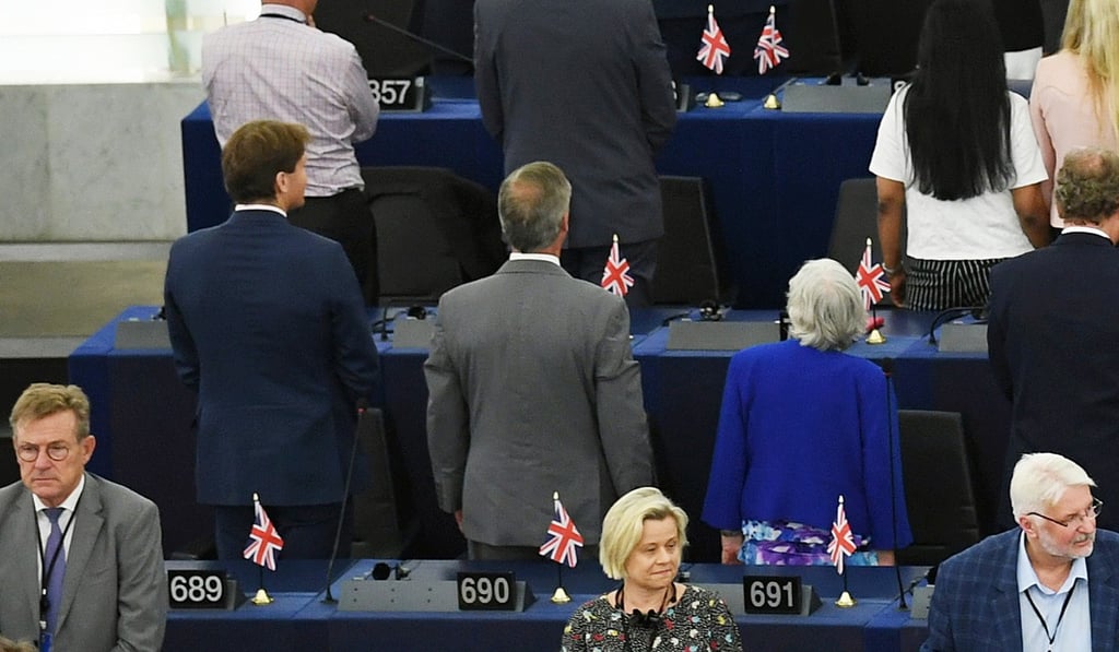 Richard James Tice, Nigel Farage and Ann Widdecombe of the Brexit Party turn their backs on the musicians during the European anthem. Photo: EPA-EFE
