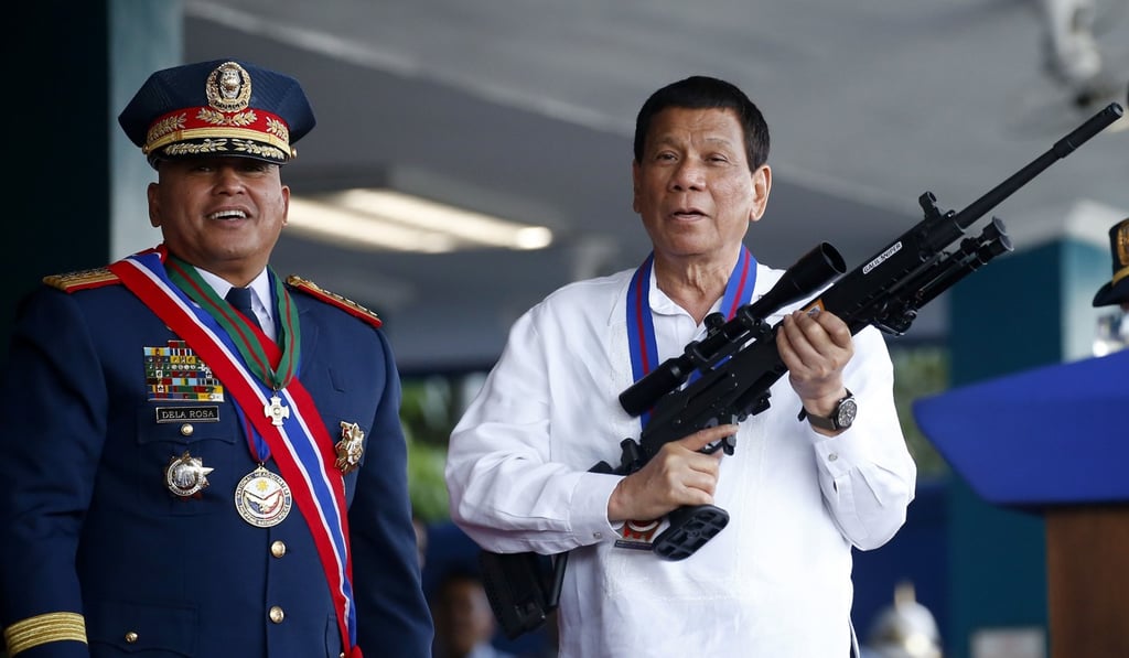 Philippine President Rodrigo Duterte holds an Israeli-made Galil rifle. More than a dozen countries have called for an investigation into Duterte’s war on drugs. Photo: AP