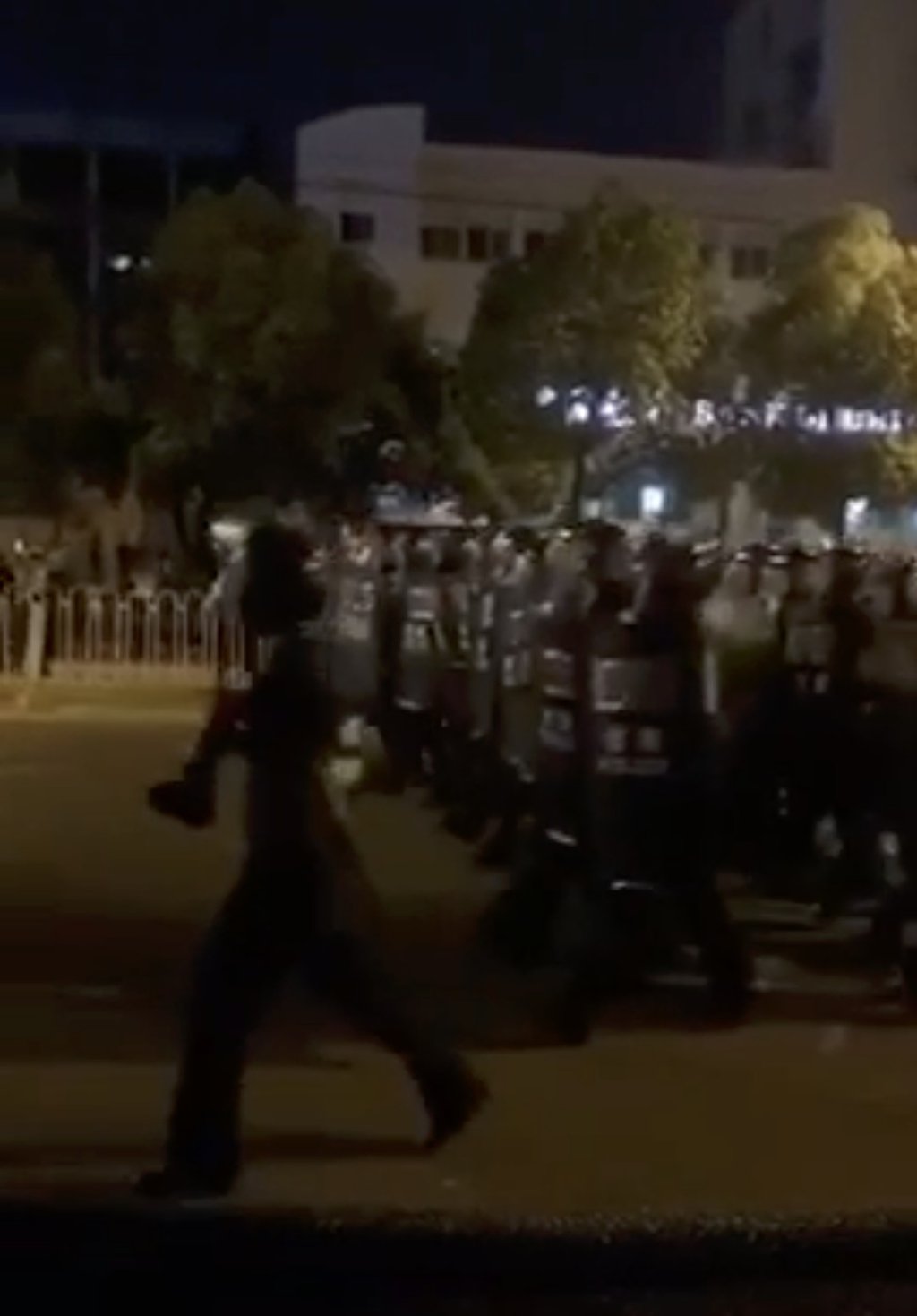 Riot police move in as protests continue in Yangluo on Thursday. Photo: Handout