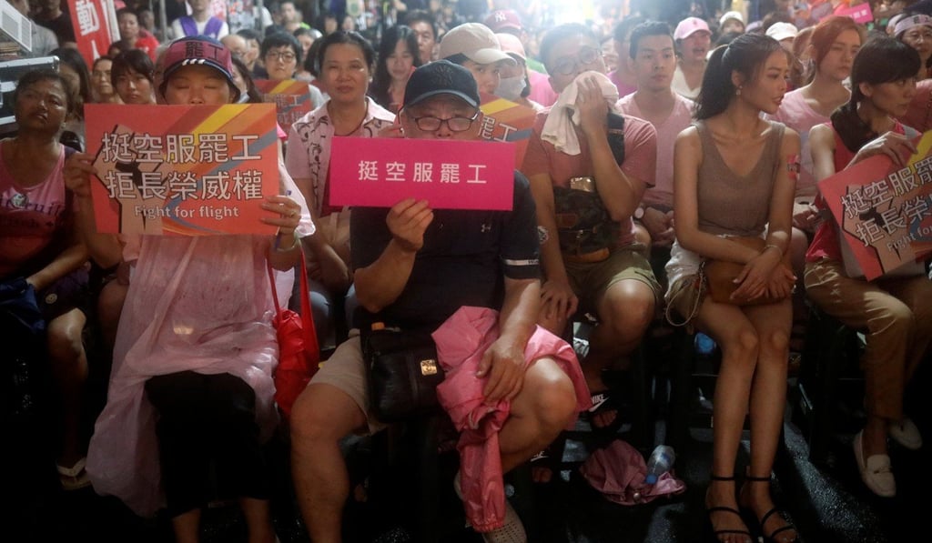 Eva flight attendants and their families at a protest last week. Photo: Reuters Eva flight attendants and their families at a protest last week. Photo: Reuters