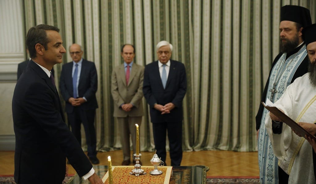 Kyriakos Mitsotakis (left) being is sworn in as Greece's new prime minister in Athens on Monday. Photo: AP Kyriakos Mitsotakis (left) being is sworn in as Greece's new prime minister in Athens on Monday. Photo: AP