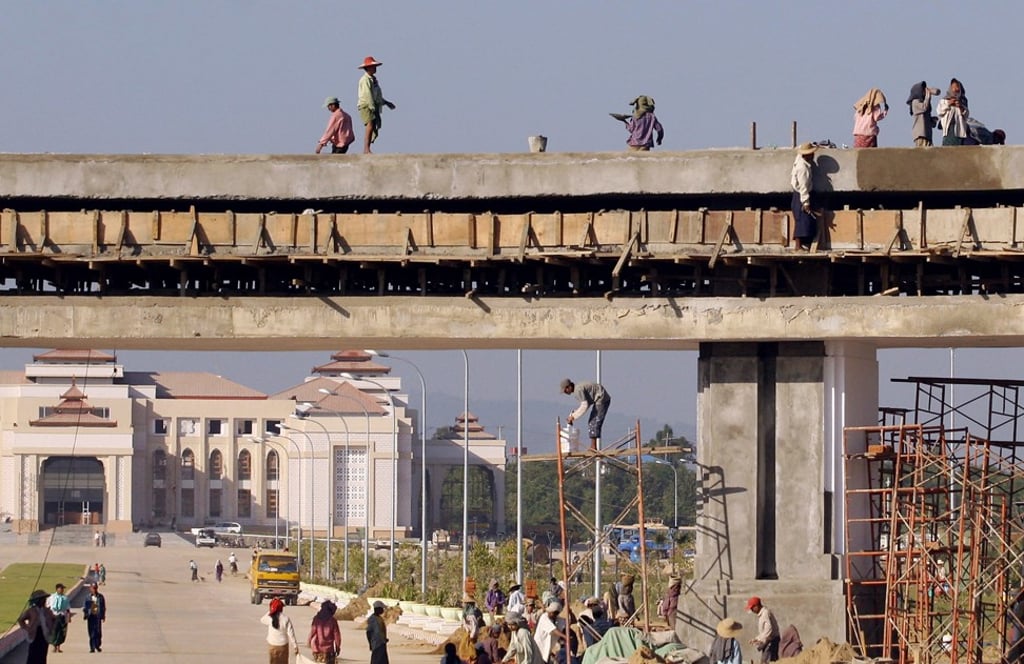 Workers construct a skyway in front of Myanmar’s government office in Naypyidaw, the nation’s new capital, in 2006. The capital was moved from Yangon that year. Photo: AFP