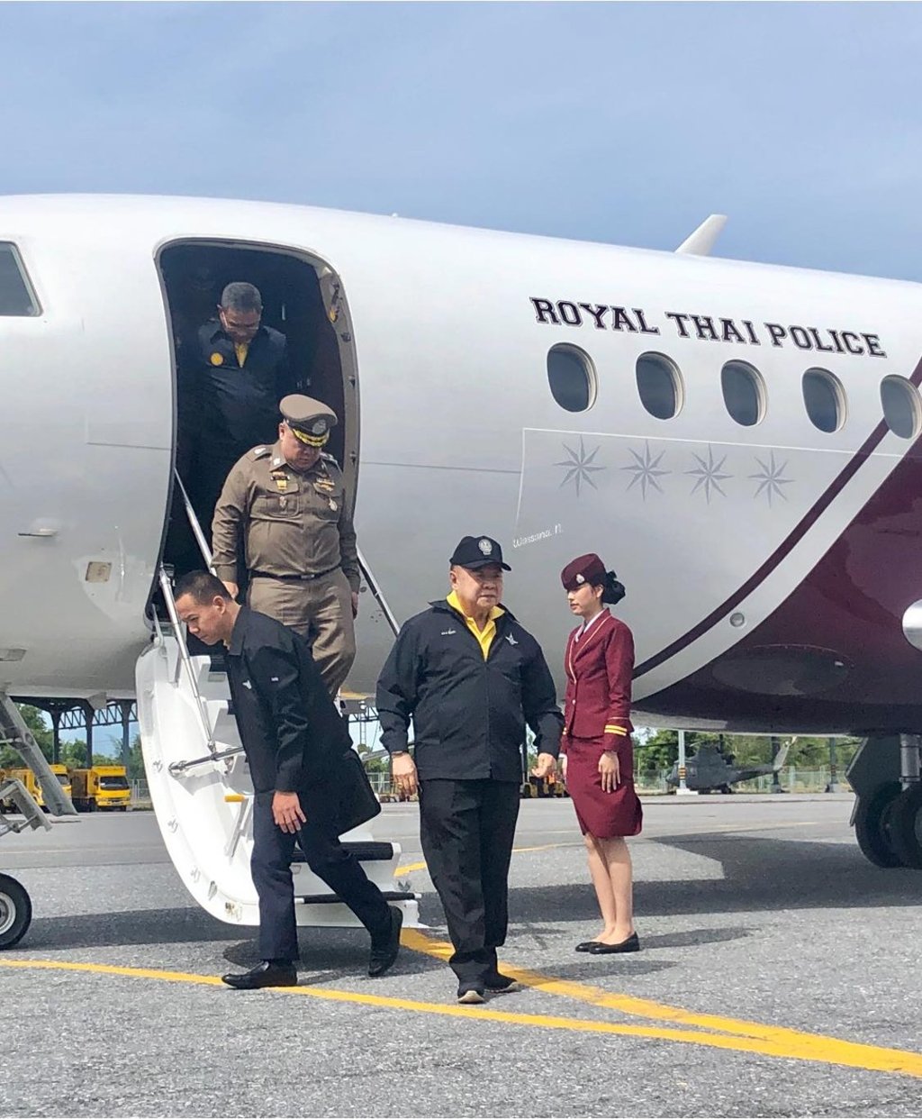 Prawit Wongsuwon with his entourage disembarking from the Royal Thai Police jet. Photo: Wassana Nanuam/Facebook