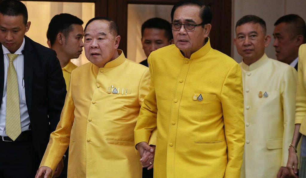 Thailand's Prime Minister Prayuth Chan-ocha holds hands with deputy prime minister and defence minister Prawit Wongsuwon ahead of the Songkran festival in Bangkok. Photo: Reuters