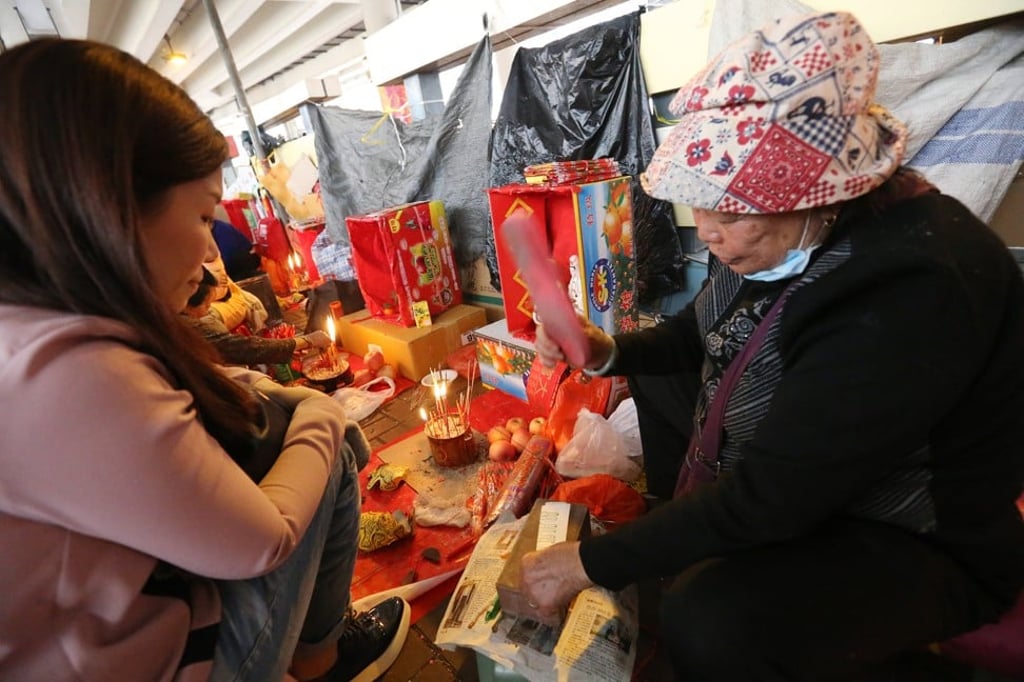 A beater pounds a paper effigy with a shoe under the Canal Road flyover during Hong Kong’s White Tiger Festival. Photo: Dickson Lee