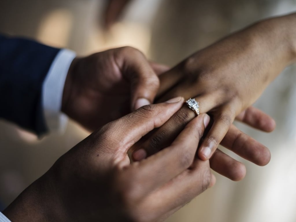 A groom places the wedding ring on the finger of his wife as they exchange their wedding vows. Photo: Shutterstock A groom places the wedding ring on the finger of his wife as they exchange their wedding vows. Photo: Shutterstock