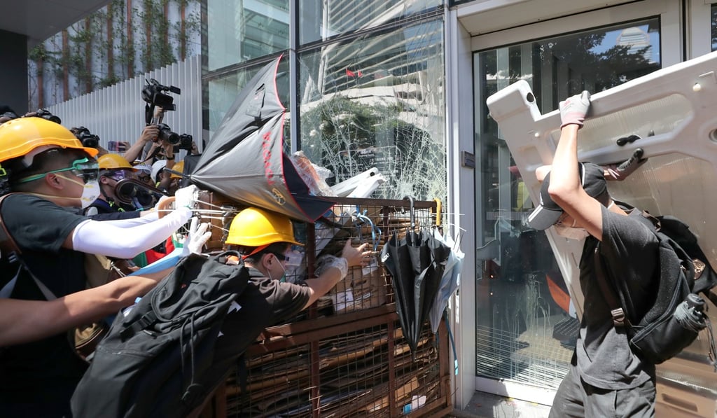 Protesters smash glass panels at the Legislative Council in Hong Kong during an 11-hour assault on the building. Photo: Sam Tsang