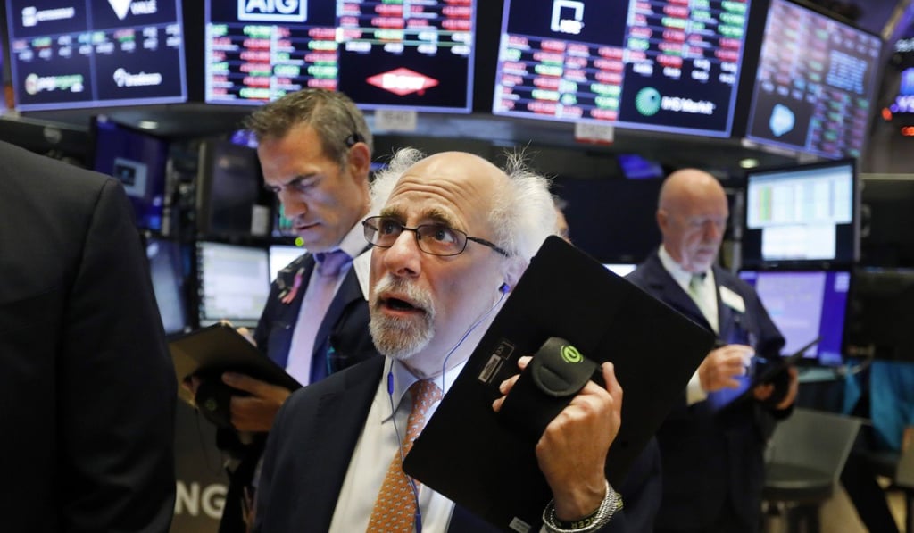 A trader works on the floor of the New York Stock Exchange on July 8. Stocks fell amid growing speculation among investors that unexpectedly strong US employment data might keep the Federal Reserve from aggressively cutting interest rates. Photo: AP
