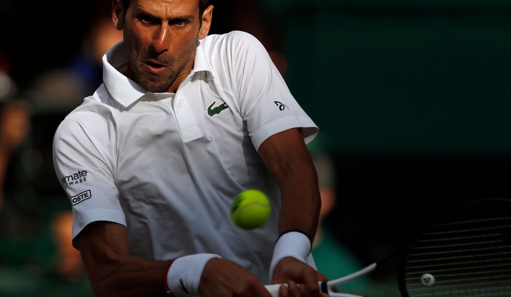 Djokovic returns against Federer during their men’s singles final. Photo: AFP