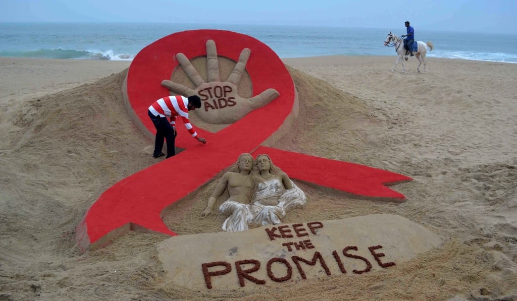A Indian sand artist makes a sculpture on the eve of World Aids Day in 2013. Photo: AFP