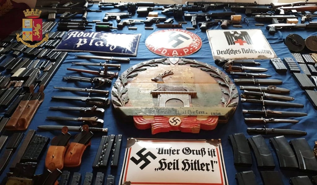 Some of the items, including a large arsenal of weapons, seized in raids on neo-Nazi sympathisers in Turin on Monday. Photo: Italian police via Reuters
