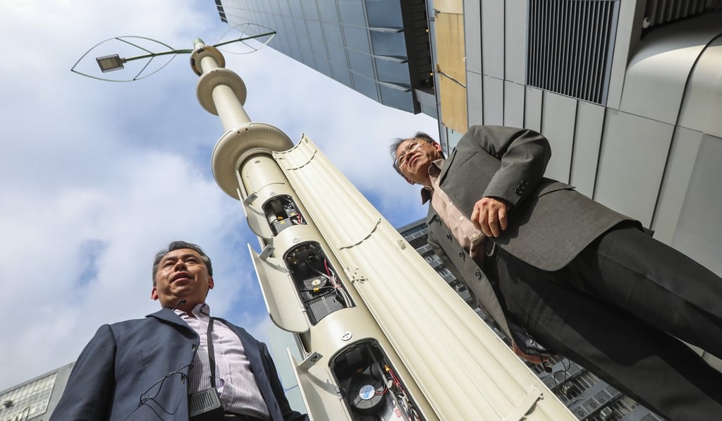 Left to right: Dantes Tang, senior systems manager, Innovation and Technology Bureau and Cheng Chung-shan, senior engineer, Highways Department with one of the new smart lamp posts. Photo: Felix Wong