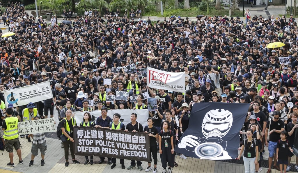 Journalists, press photographers and academics take part in a silent march against police mistreatment of journalists on Sunday. Photo: Edmond So