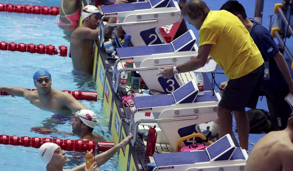 China's Sun Yang (bottom left) listens to coach Denis Cotterell (right) in the Gwangju pool. Photo: AP