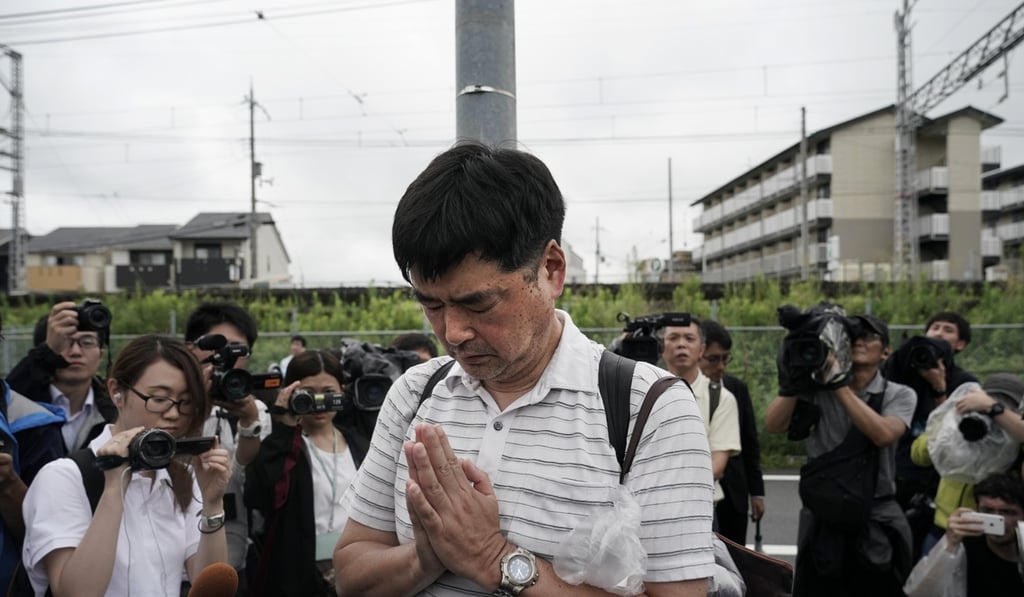 A man prays for the victims of Thursday's fire at the Kyoto Animation Studio building. Photo: AP