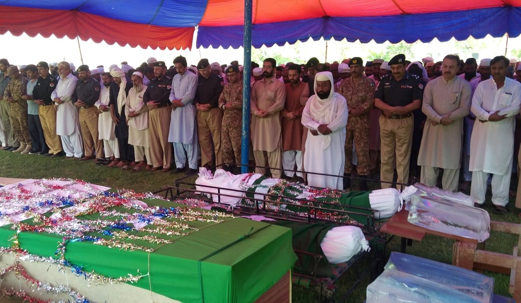 Police officers, soldiers and relatives attend a funeral prayer for victims of the suicide blast. Photo: Reuters