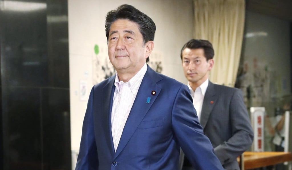 Japanese Prime Minister Shinzo Abe enters the headquarters of his Liberal Democratic Party in Tokyo on Sunday. Photo: AP