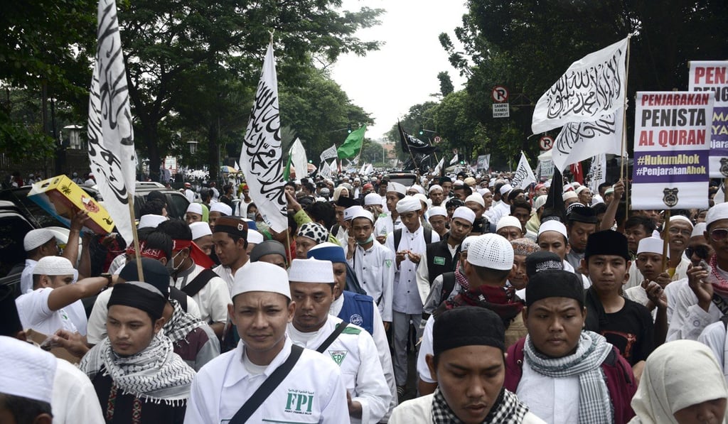 Muslim protesters march through the streets of Jakarta in 2017 to protest against Purnama, who was on trial for blasphemy at the time. Photo: AFP