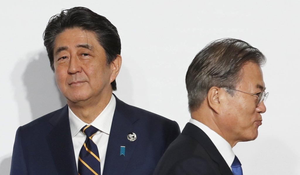 South Korean President Moon Jae-in (right) walks past Japanese Prime Minister Shinzo Abe at the G20 summit last month. Japan has not said the political issue prompted the measures. Photo: Bloomberg