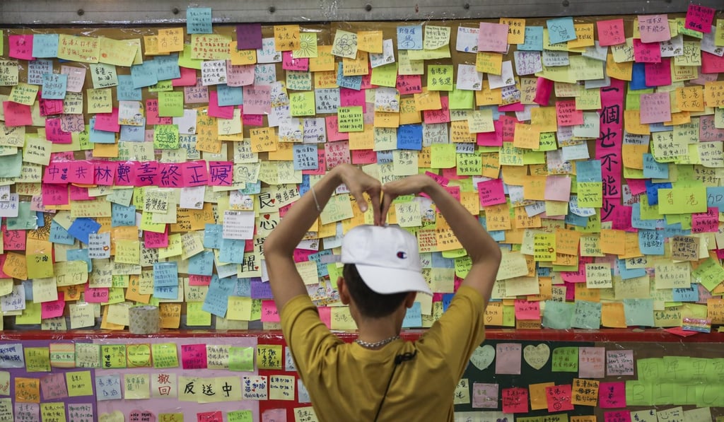 A member of the public in front of the Lennon Wall at Tsuen Wan. Photo: Sam Tsang