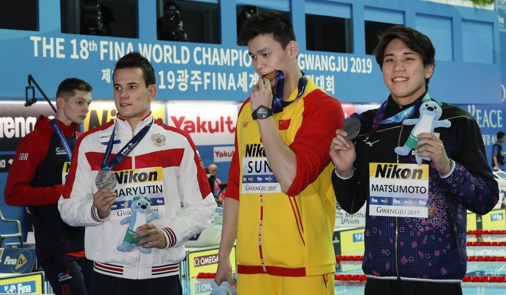 Britain's bronze medallist Duncan Scott refuses to join gold medallist Sun Yang on the podium. Photo: AP Britain's bronze medallist Duncan Scott refuses to join gold medallist Sun Yang on the podium. Photo: AP