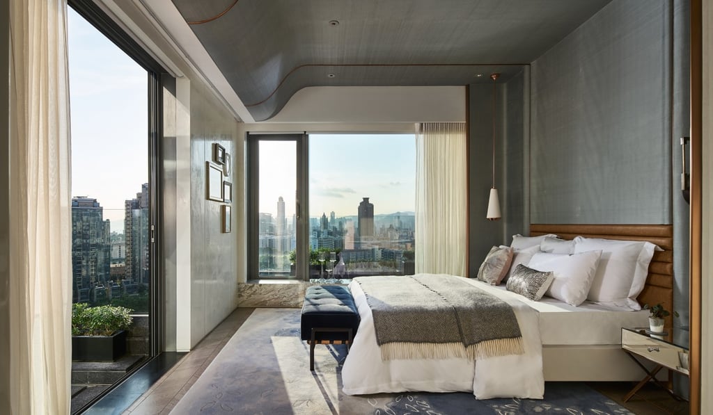 A three-level hillside penthouse at Ho Man Tin, in Kowloon, Hong Kong, designed by AB Concept, has fine views across the neighbouring mountain and distant Victoria Harbour.