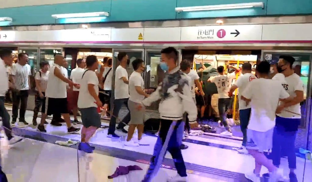 A mob of men in white T-shirts attack protesters and passengers at Yuen Long MTR station on Sunday night. Photo: Handout A mob of men in white T-shirts attack protesters and passengers at Yuen Long MTR station on Sunday night. Photo: Handout
