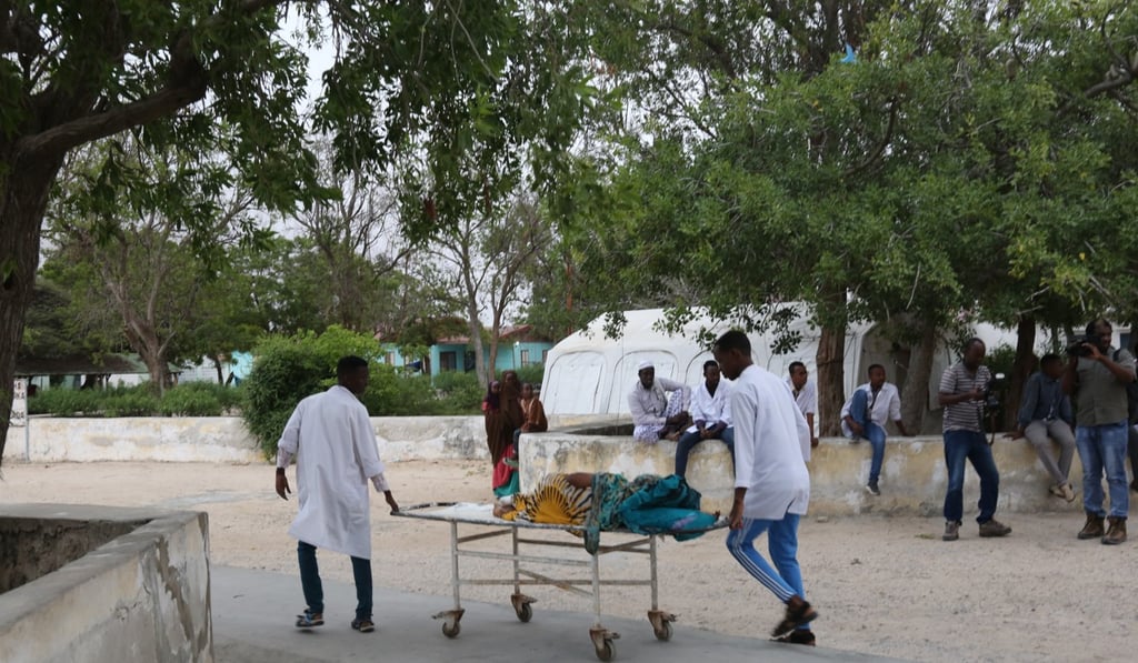 People carry a wounded person on a stretcher after a suicide attack at Mogadishu mayor’s offices. Photo: Xinhua