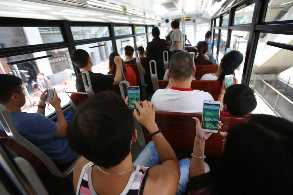 People playing Pokemon Go on the tram in Hong Kong’s Admiralty area in August 2016. The slow speed of trams provides good conditions for Pokemon hunting. Photo: Edward Wong