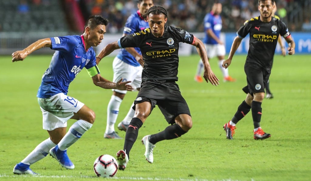 Kitchee captain Huang Yang tries to evade Leroy Sane of Manchester City. Photo: K.Y. Cheng