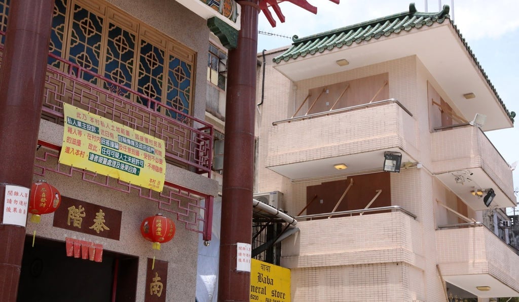 Glass doors in the village were covered with wooden boards. Photo: K.Y. Cheng