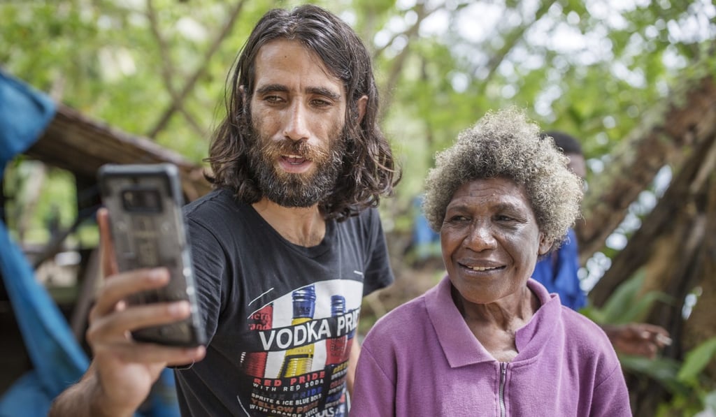 Boochani takes a selfie with a local on Manus Island. Photo: Jonas Gratzer