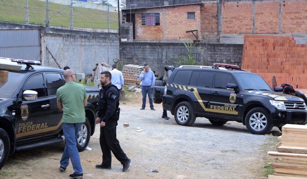 Police inspect the vehicles that were left by suspects involved in the heist. Photo: AP Police inspect the vehicles that were left by suspects involved in the heist. Photo: AP