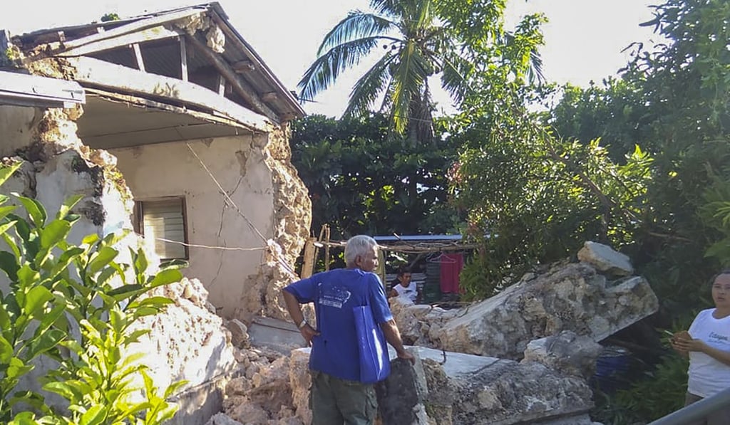 A resident looks at damaged houses in Itbayat town. Photo: AP