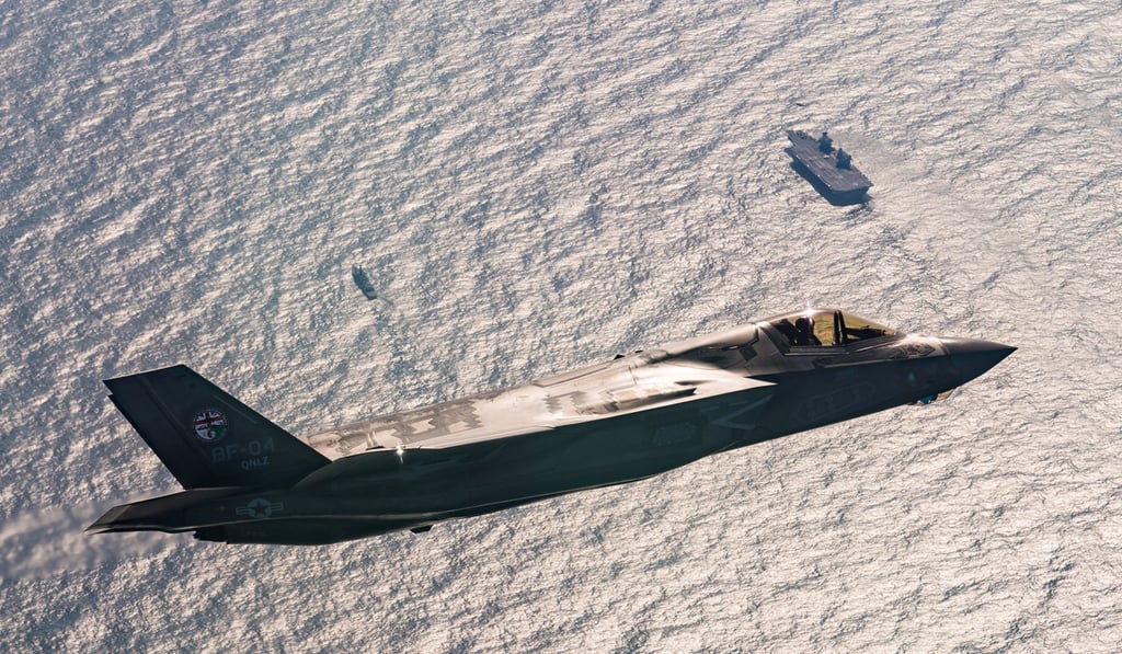 An F-35B fighter jet flies above the HMS Queen Elizabeth. Photo: Lockeed Martin An F-35B fighter jet flies above the HMS Queen Elizabeth. Photo: Lockeed Martin